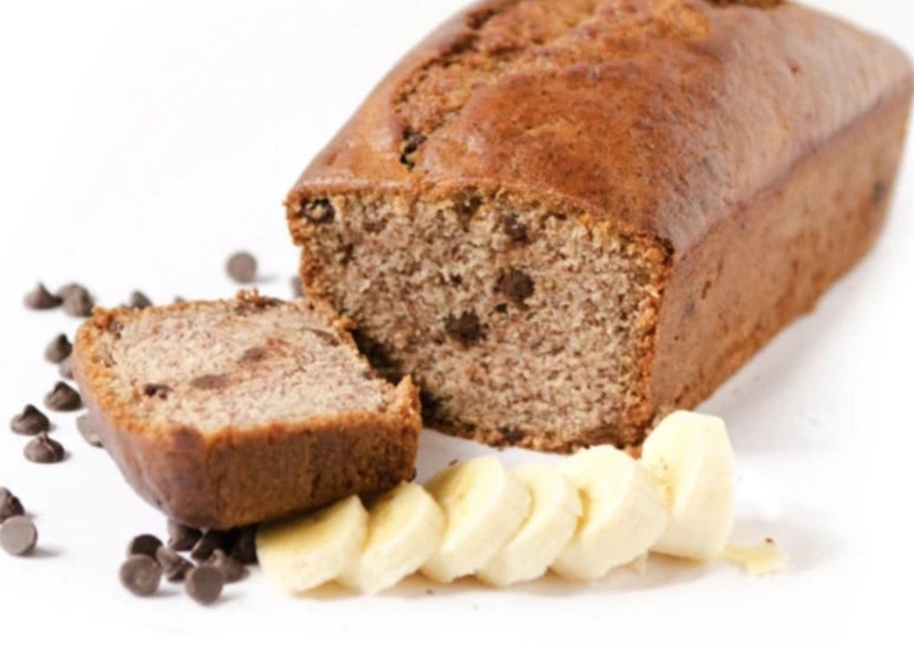 Banana bread with slice bananas and chocolate chips against a white background