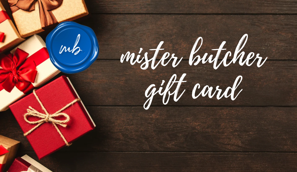 Wrapped gift boxes and blue mister butcher logo on a dark brown wood background titled “mister butcher gift card”