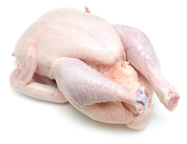 Fresh whole chicken against a white background