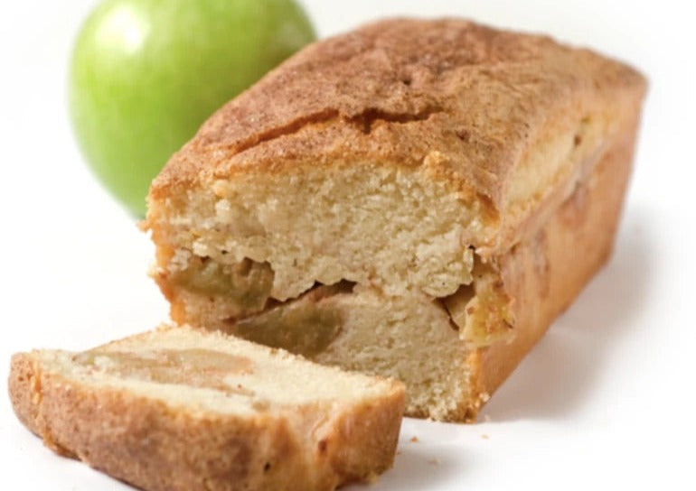 Slice apple cinnamon loaf with green apple in the background